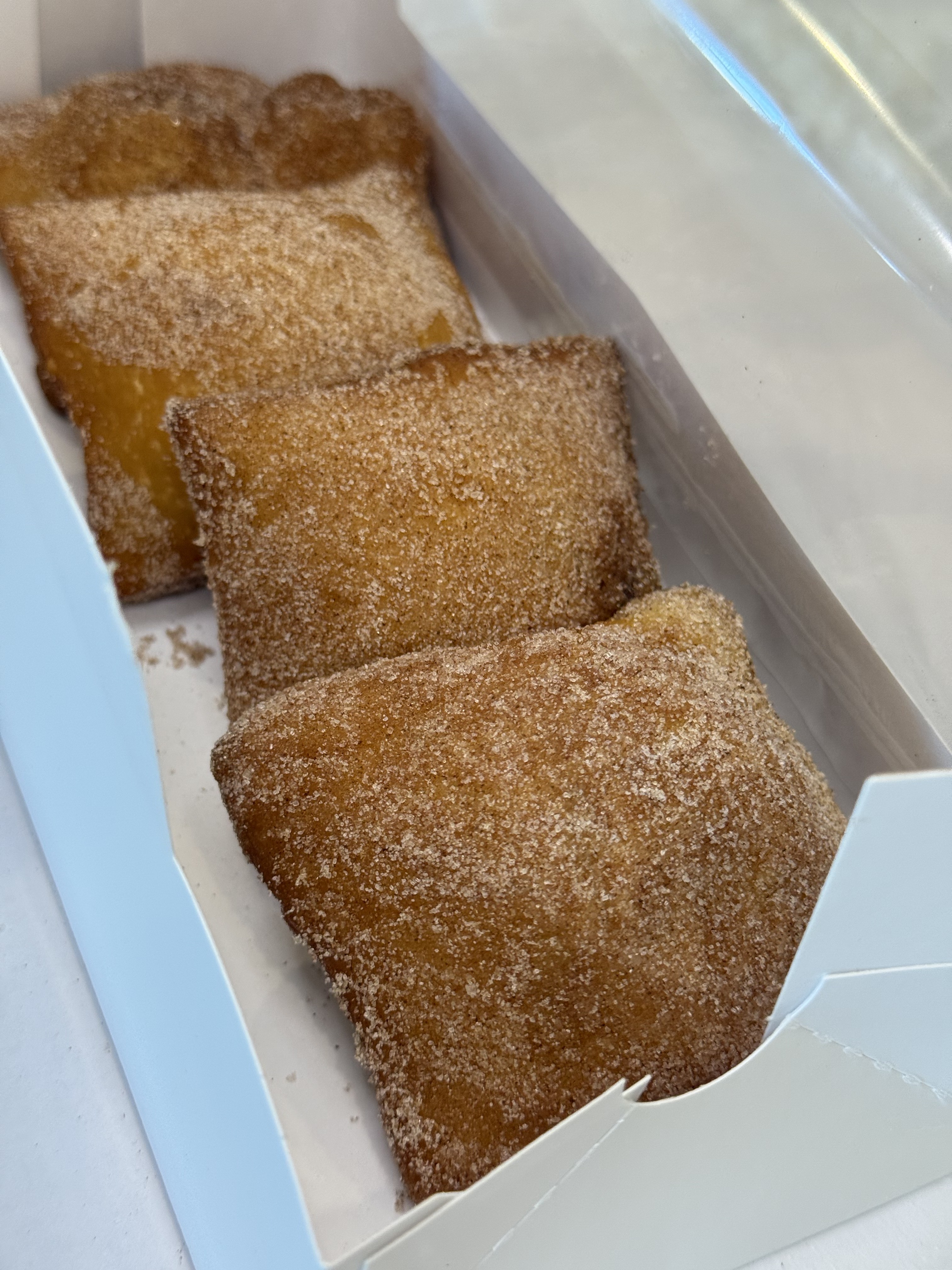 Cinnamon Sugar beignets in an open pastry box